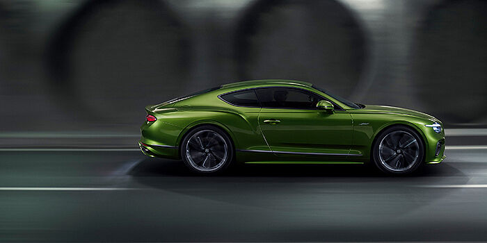  Jack Barclay Bentley Continental GT coupe in Tourmaline Green paint driving in profile on a dark road