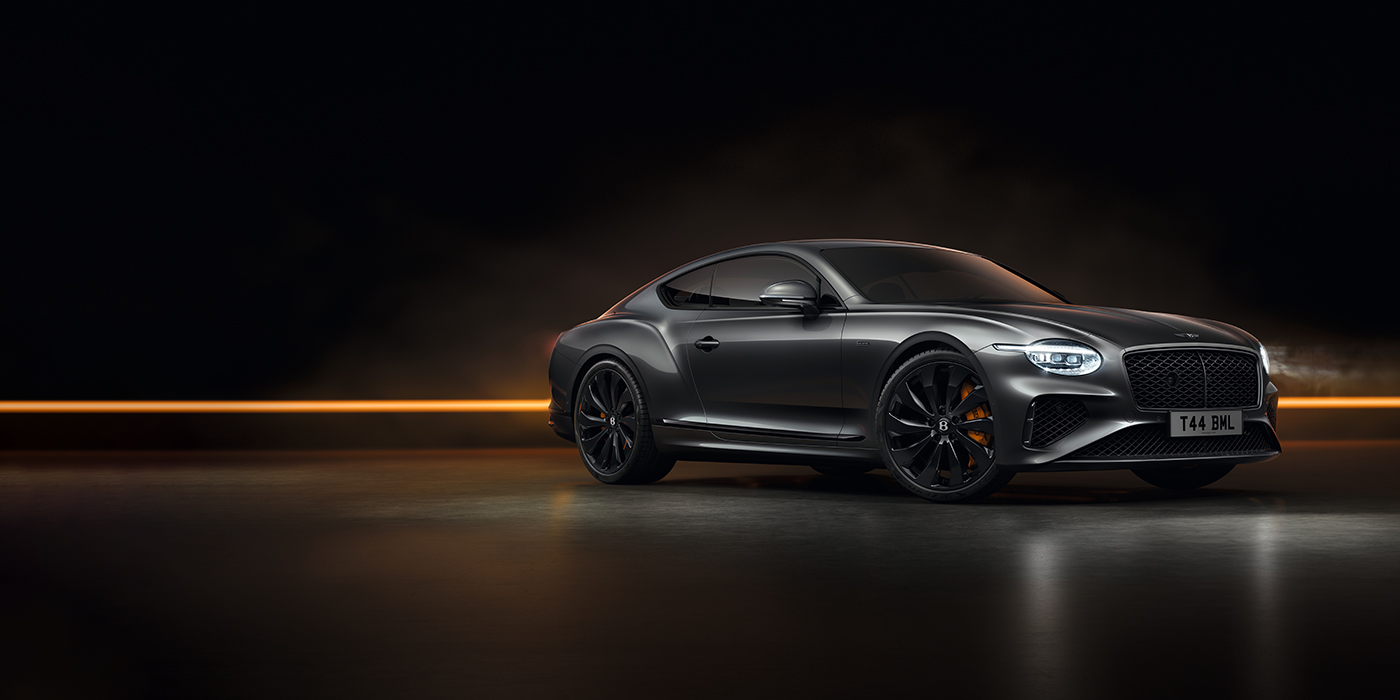 Jack Barclay Bentley Continental GT Black Edition coupe front three quarter in Anthracite black paint against a dark grey and copper background