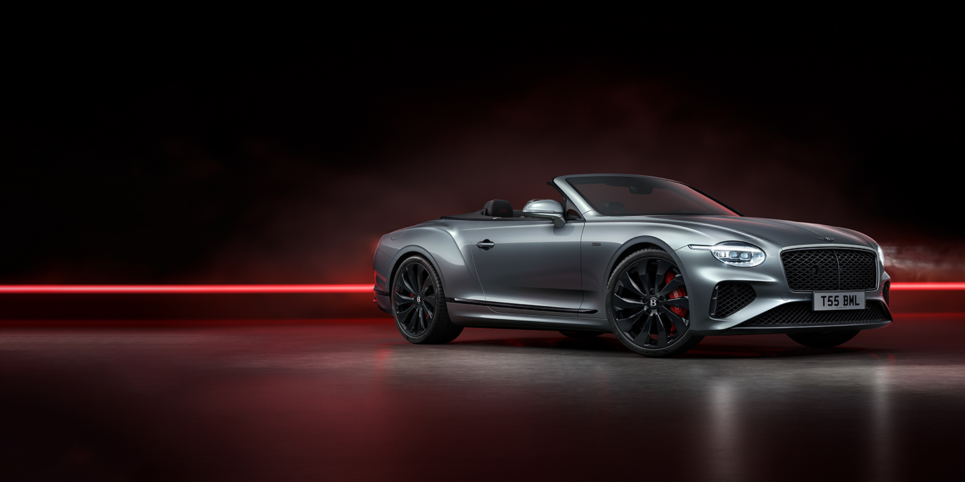 Jack Barclay Bentley Continental GTC Black Edition convertible front three quarters in Hallmark silver against a dark grey and red background