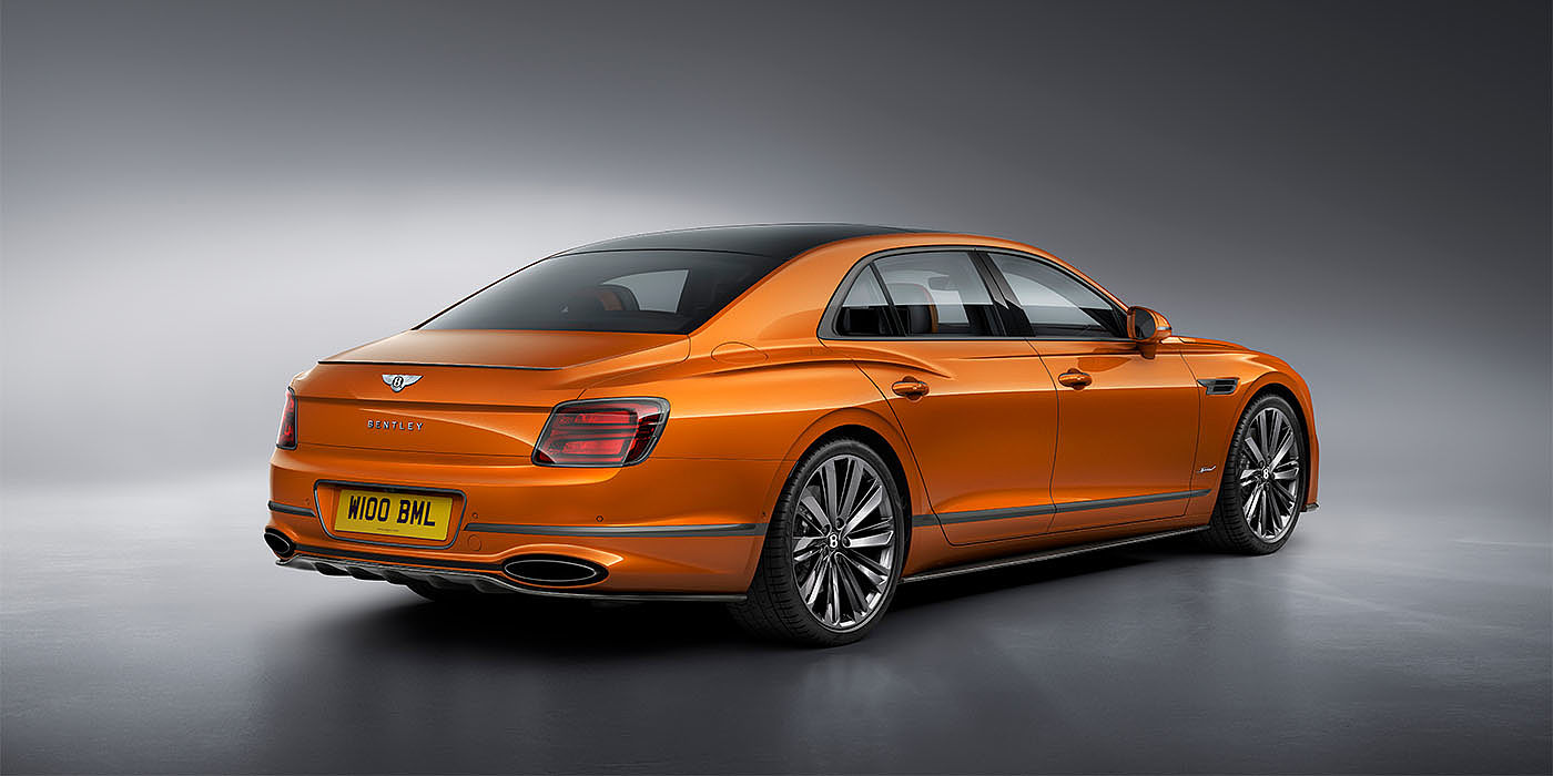 Jack Barclay Bentley Flying Spur Speed in Orange Flame colour rear view, featuring Bentley insignia and enhanced exhaust muffler.
