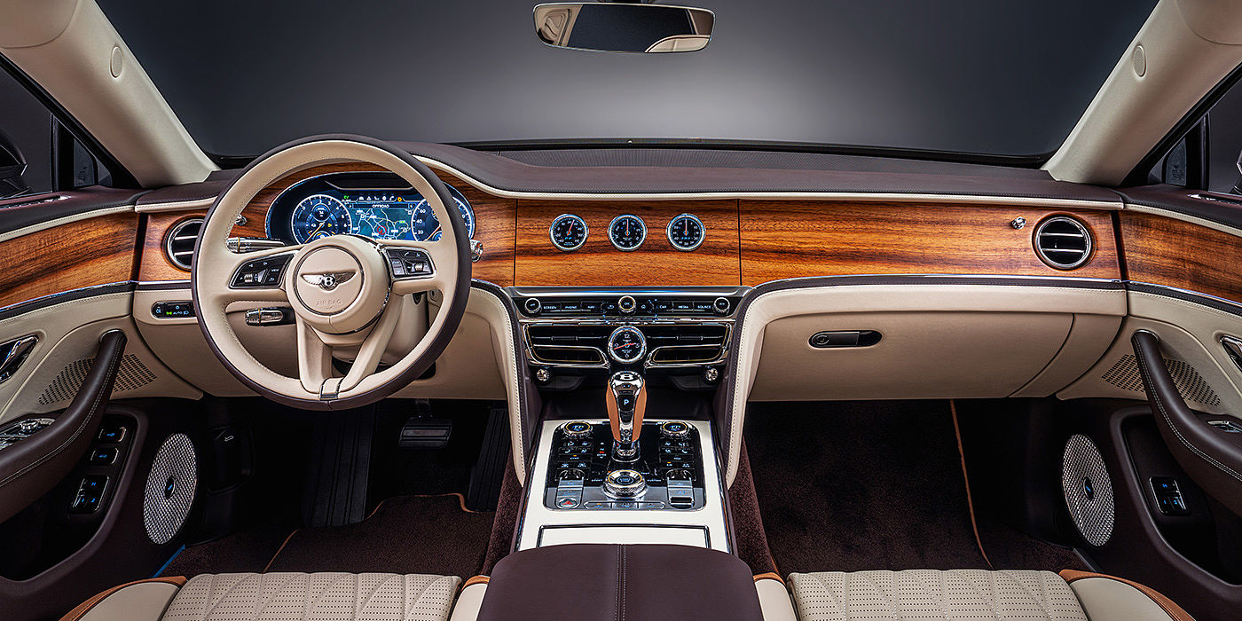 Jack Barclay Bentley Flying Spur Odyssean sedan front interior in Open Pore Koa veneer with Piano Linen console and Linen and Burnt Oak hides