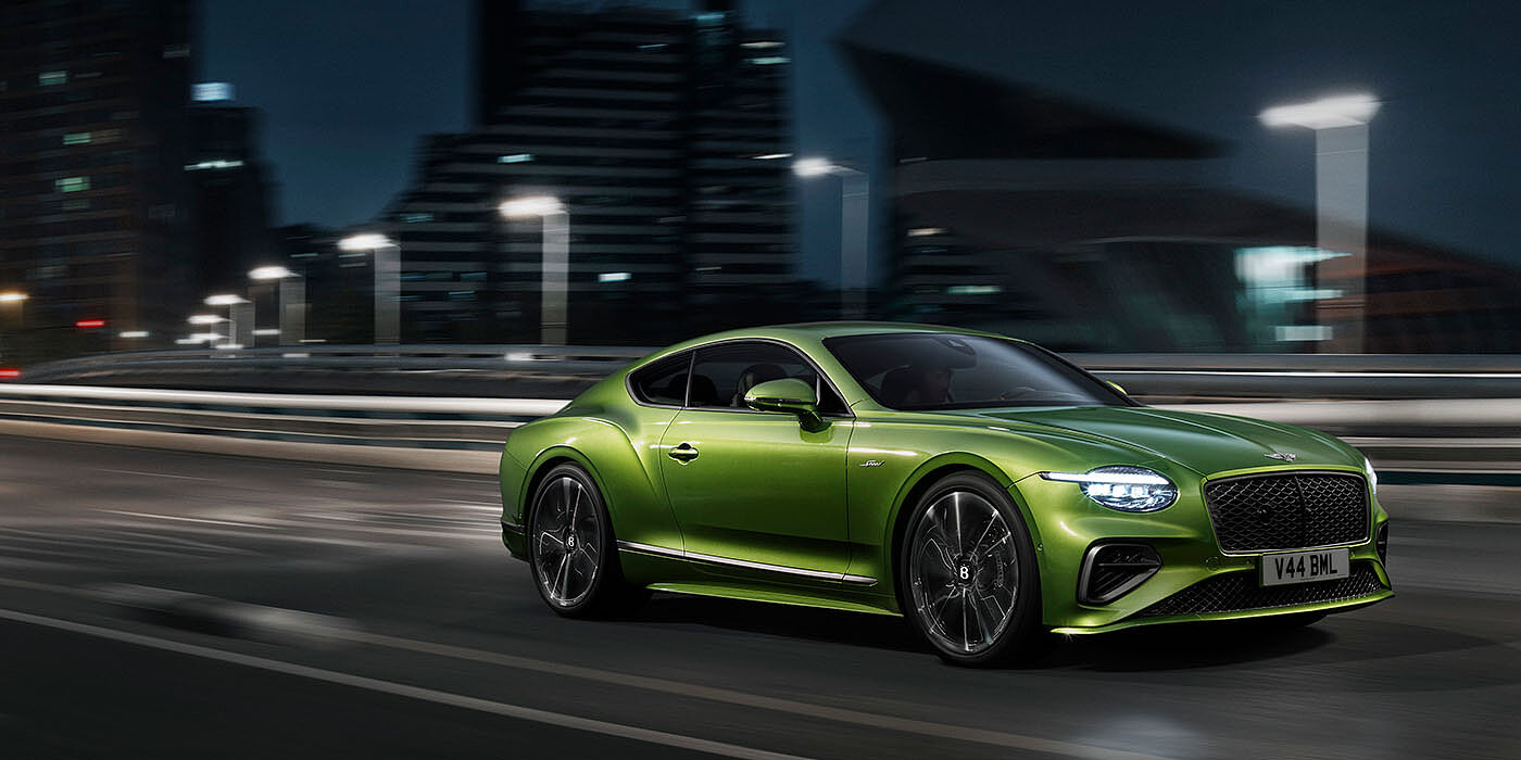 Jack Barclay Bentley New Continental GT Speed driving dynamically at night in Tourmaline Green paint