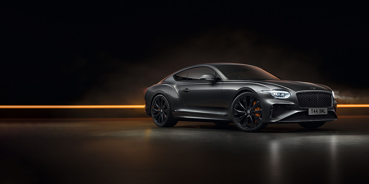 Jack Barclay Bentley Continental GT Black Edition coupe front three quarter in Anthracite black paint against a dark grey and copper background