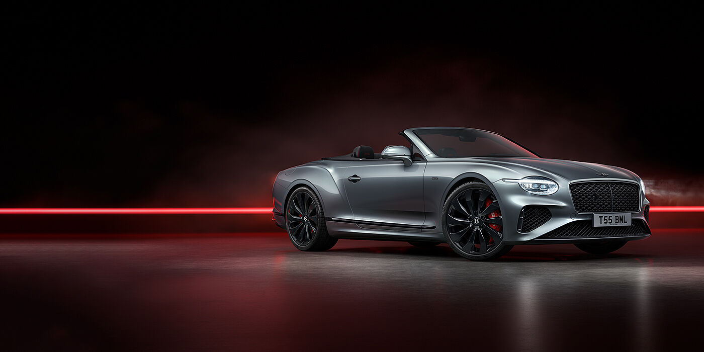 Jack Barclay Bentley Continental GTC Black Edition convertible front three quarters in Hallmark silver against a dark grey and red background
