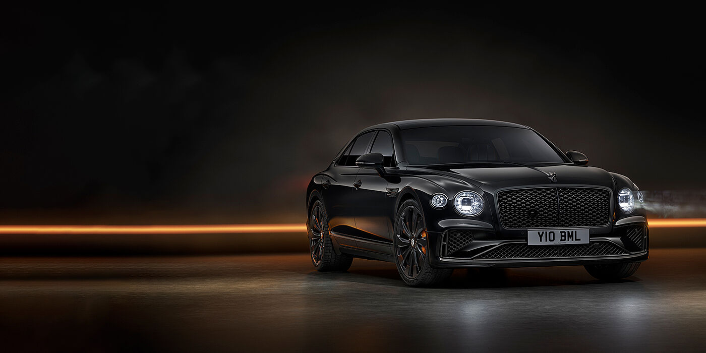 Jack Barclay Bentley Flying Spur Black Edition sedan in Black Crystal paint against a dark grey and copper coloured background