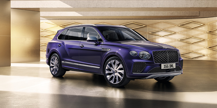 Jack Barclay Bentley Bentayga Extended Wheelbase Mulliner SUV front three quarter in Tanzanite Purple paint with a gold patterned background