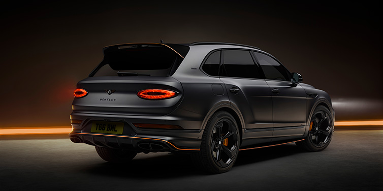 Jack Barclay Bentley Bentayga S Black Edition SUV rear three quarter in Anthracite Satin paint against a dark red and yellow background