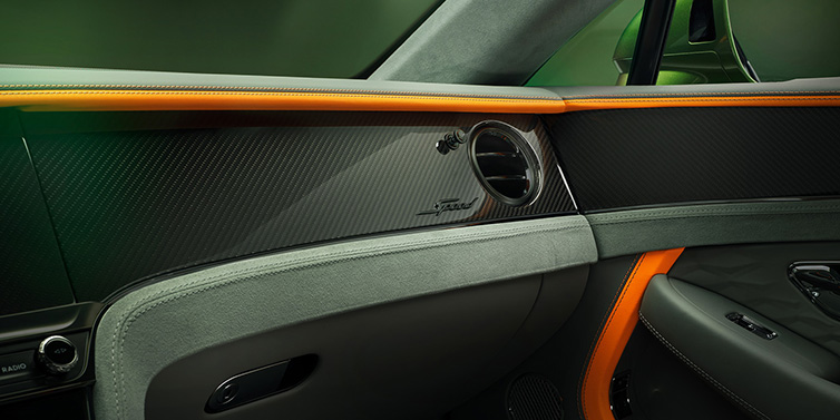 Jack Barclay Bentley Continental GT Speed coupe front interior dash detail with high gloss carbon fibre veneer surrounded by Mandarin by Mulliner and Gravity Grey hides