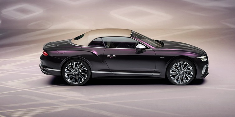 Jack Barclay Bentley Continental GTC Mulliner convertible in profile with hood up, in Tanzanite Purple paint and 22 inch Mulliner painted and polished wheels