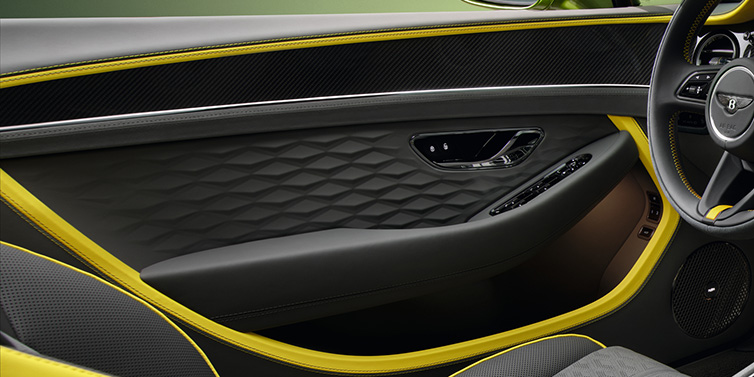 Jack Barclay Bentley Continental GTC Speed convertible interior door details featuring Gravity Grey and Cyber Yellow by Mulliner hides and high gloss carbon fibre veneer