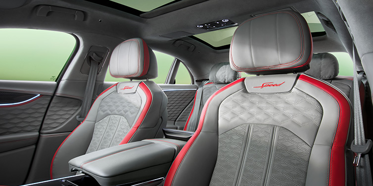 Jack Barclay Bentley Flying Spur Speed sedan interior showing front and rear seats in Hotspur red and Gravity Grey hides, with Speed seat emblems