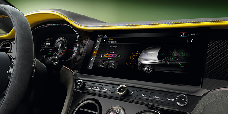 Jack Barclay Bentley Continental GTC Speed convertible front interior centre console with MMI screen showing Air Quality visualisation surrounded by Cyber Yellow by Mulliner and Gravity Grey hides and high gloss carbon fibre veneer