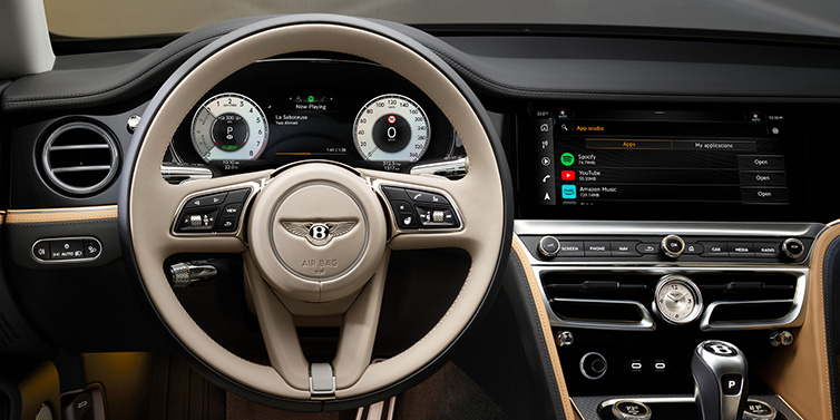 Jack Barclay Bentley Flying Spur Mulliner sedan front interior detail of steering wheel and driver screens surrounded by Linen and Beluga black hides