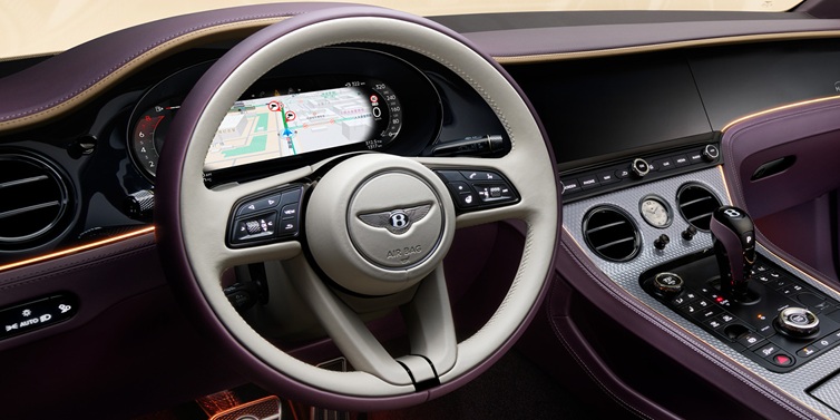 Jack Barclay Bentley Continental GT Mulliner coupe front interior showing steering wheel and drivers screens surrounded by Linen and Damson hides and Grand Black veneer